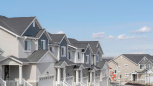 Looking downhill at a string of similar-looking houses in a nice neighborhood